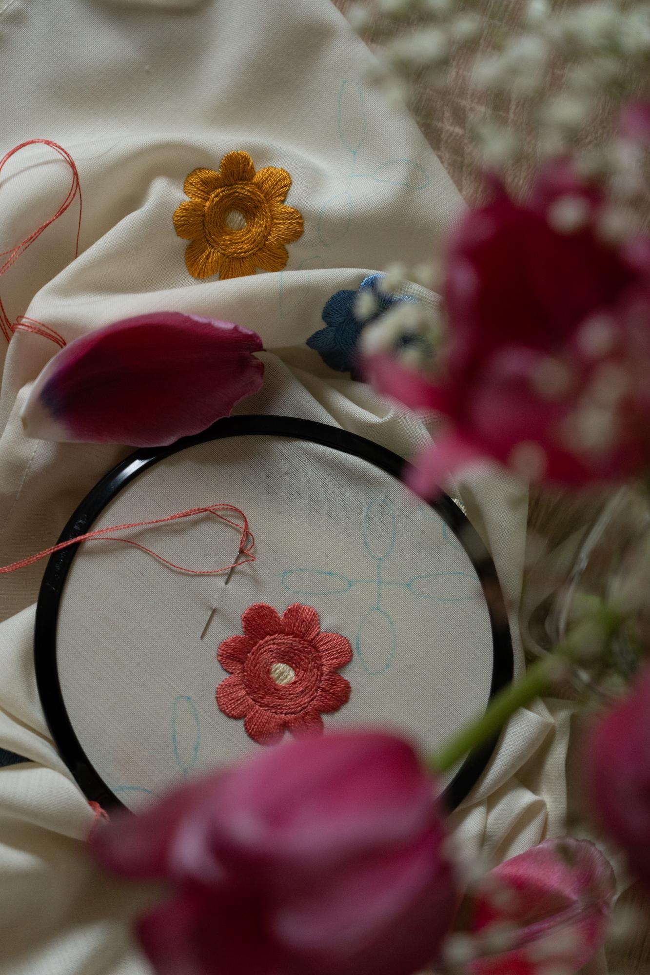 Close-up of embroidered floral patch on linen